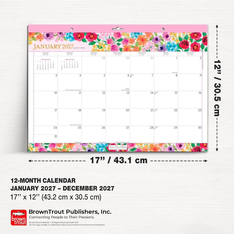 May include: A 12-month wall calendar for January 2027 through December 2027, measuring 17 inches by 12 inches. The calendar features a colorful floral border at the top and bottom, with a grid layout for January 2027 and BrownTrout branding.