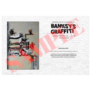 May include: A certificate of authenticity for Banksy's Graffiti, featuring a limited edition print of "Barbican Man" (2017). The artwork depicts a Basquiat-style graffiti scene with police officers. The certificate is numbered 115/300.