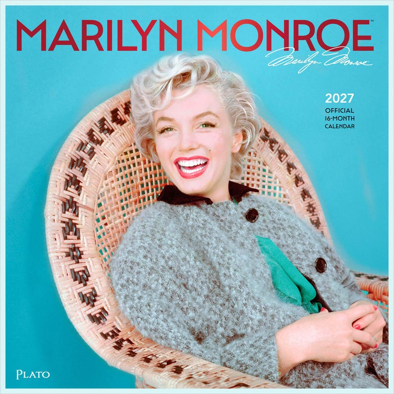 K&ouml;nnte beinhalten: Ein offizieller 16-Monats-Kalender f&uuml;r 2027 mit einem Portr&auml;t von Marilyn Monroe auf dem Cover. Das Bild zeigt eine l&auml;chelnde blonde Person in einer grauen, strukturierten Jacke, die in einem hellbraunen Korbstuhl vor blauem Hintergrund sitzt.