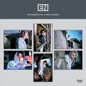 May include: The ENHYPEN 2027 official 16-month calendar features a dark gray header with the EN logo and text. Below, five distinct photographic panels display various portraits of the group members in outdoor settings with stone architecture.
