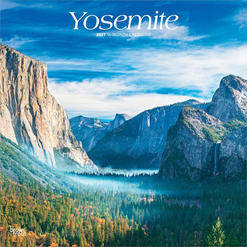 May include: A 2027 16-month calendar featuring a landscape photograph of Yosemite National Park. The image displays towering granite cliffs, a dense evergreen forest, and a waterfall under a bright blue sky with white clouds. Text reads Yosemite.