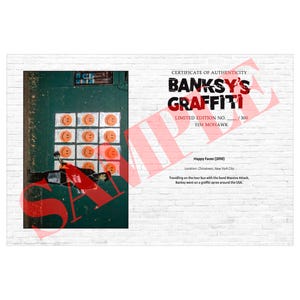 May include: A certificate of authenticity for Banksy's Graffiti, featuring a section of a green door with orange smiley faces. The text reads "Happy Faces (2010)" and "Limited Edition No. 115 Mohawk". The background is a white brick wall.