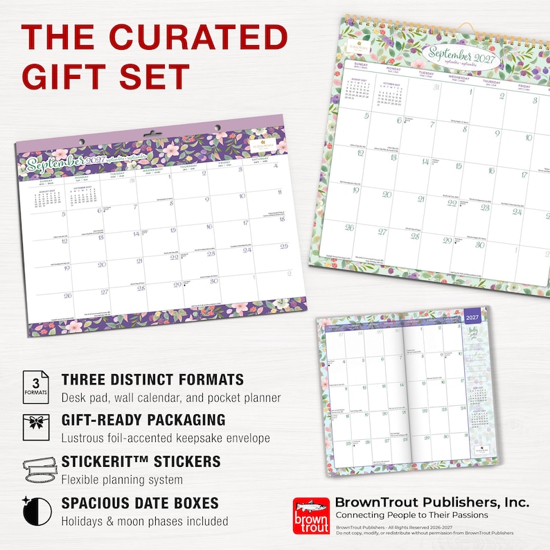 May include: A curated gift set featuring a desk pad, a wall calendar, and a pocket planner for September 2027. Each item displays a floral border design with spacious date boxes, moon phases, and holidays. The set includes sticker sheets.