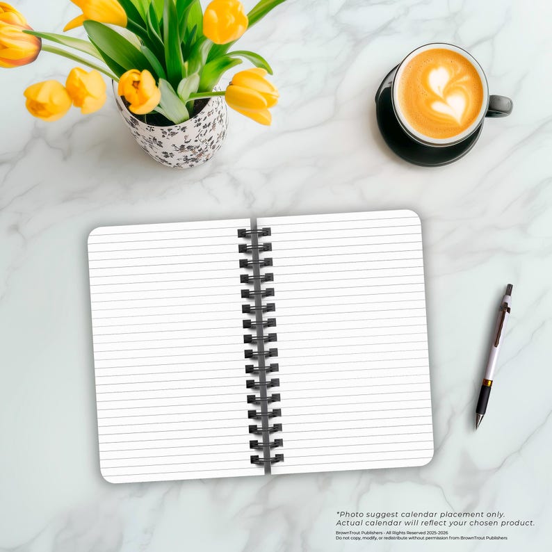 May include: An open spiral bound notebook with lined pages. The notebook is on a white marble surface with a cup of coffee and a pen.