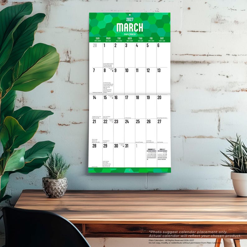 May include: A vertical wall calendar for March 2027 featuring a green hexagonal pattern at the top and bottom. The calendar displays the month name in large white text, followed by a grid of days from the 1st to the 31st with small text entries.
