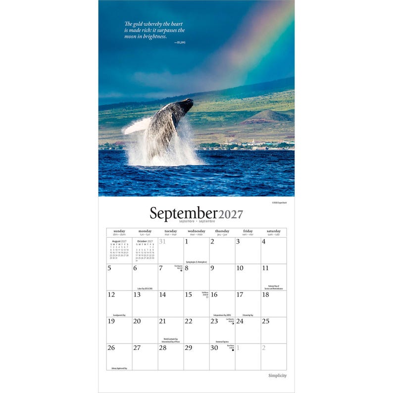 May include: A September 2027 wall calendar featuring a photograph of a humpback whale breaching in deep blue ocean water with a rainbow in the sky above a coastal landscape. The text reads: The gold whereby the heart is made rich: it surpasses the moon in brightness.
