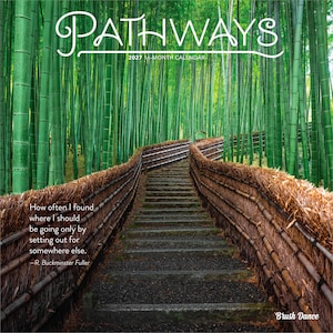 May include: A 2027 16-month calendar titled PATHWAYS featuring a photograph of a stone staircase winding through a dense green bamboo forest, flanked by textured brown thatched fences, with a quote by R. Buckminster Fuller and Brush Dance text.