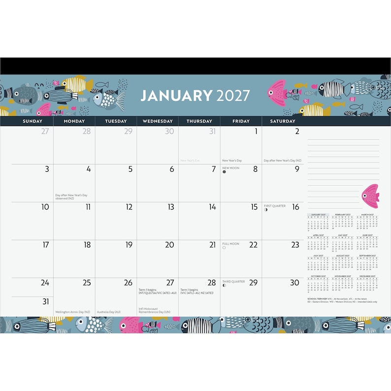 May include: A January 2027 desk calendar featuring a blue header and footer decorated with colorful fish illustrations. The grid displays dates, holidays, and moon phases, with a lined notes section on the right and a full-year calendar overview.