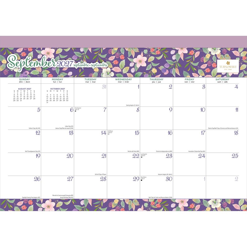 May include: A September 2027 wall calendar featuring a purple background with a floral pattern of pink flowers, green leaves, and small berries. The calendar grid includes days of the week, dates, and small text for holidays. The Turnowsky logo is visible.
