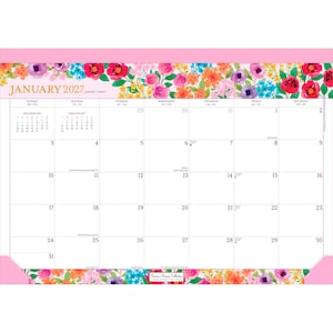 May include: A January 2027 desk calendar featuring a vibrant floral border with pink, orange, purple, and blue flowers. The top and bottom edges are framed in solid pink. The grid displays dates, days of the week, and small monthly calendars.