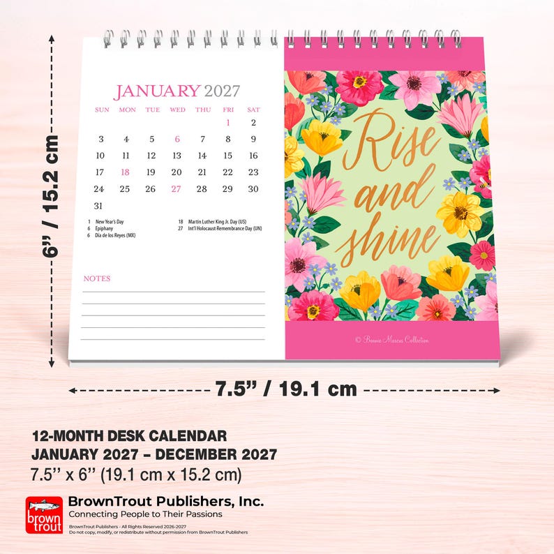 May include: A 12-month desk calendar for January 2027 measuring 7.5 inches by 6 inches. The left page shows the January calendar grid, while the right page features a floral border with the text Rise and shine in gold script lettering.