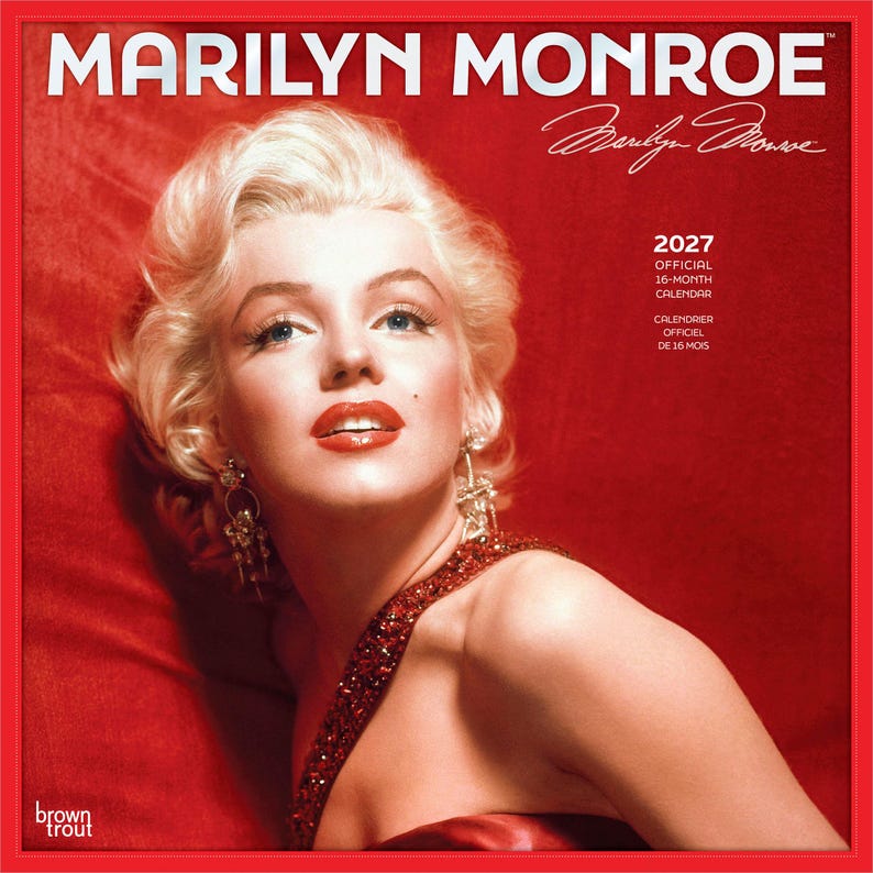 May include: A 2027 official 16-month calendar featuring a portrait of Marilyn Monroe against a red background. The text reads MARILYN MONROE, a signature, 2027 OFFICIAL 16-MONTH CALENDAR, CALENDRIER OFFICIEL DE 16 MOIS, and the brand name brown trout.