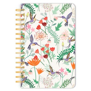 May include: A white spiral bound notebook with a colorful floral and hummingbird pattern. The cover features a repeating design of pink, red, orange, green, and purple flowers with hummingbirds flying among them.