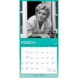 May include: A 2027 wall calendar page for the month of March featuring a black and white photograph of Marilyn Monroe wearing a robe. The calendar grid displays the days of the month with the text MARCH and 2027 printed at the top in white.