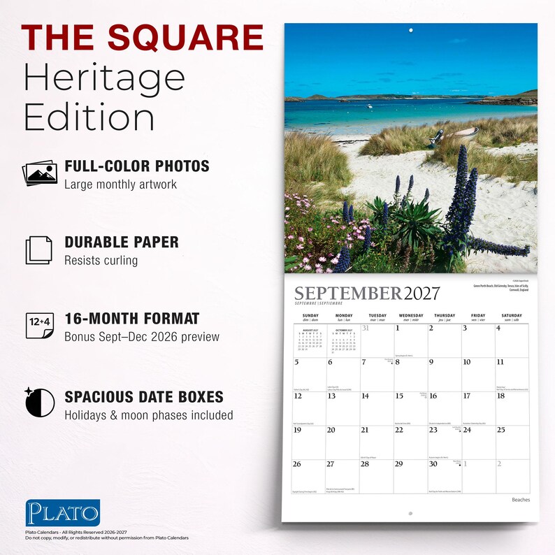 May include: A 16-month wall calendar titled The Square Heritage Edition, featuring a full-colour photograph of a sandy beach with blue water, tall grasses, and purple flowers for September 2027. The calendar includes spacious date boxes, holidays, and moon phases.