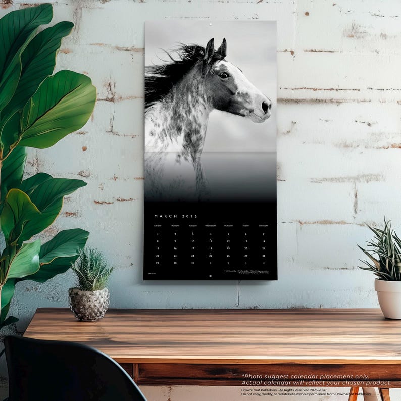 May include: A black and white 2024 calendar featuring a horse's head. The calendar has a black background with white text for the month of March and the days of the month. The calendar is hanging on a white brick wall.