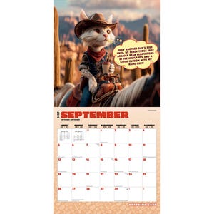May include: A 2027 wall calendar for September featuring a cat dressed as a cowboy riding a horse in a desert. The cat holds a coffee cup and a speech bubble reads: Only another day's ride until we reach those vast Arabica bean plantations in the highlands and a litter outbox with my name on it.