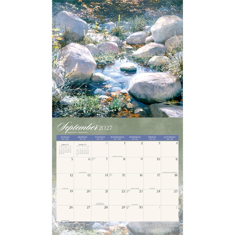 May include: A wall calendar for September 2027 featuring a nature photograph of a clear stream flowing between large, smooth grey rocks and green vegetation. The calendar grid displays the days of the month with a soft green background.