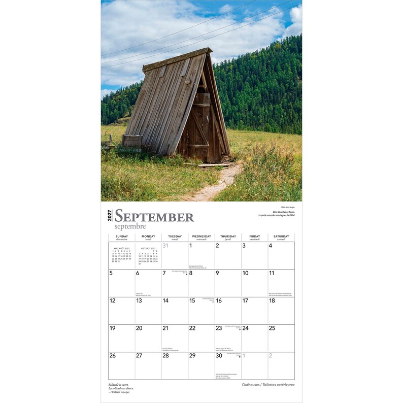 May include: A 2027 wall calendar for the month of September featuring a photograph of a wooden A-frame structure in a grassy field with a forest and blue sky in the background. The calendar grid displays dates from 1 to 30 with text in English.