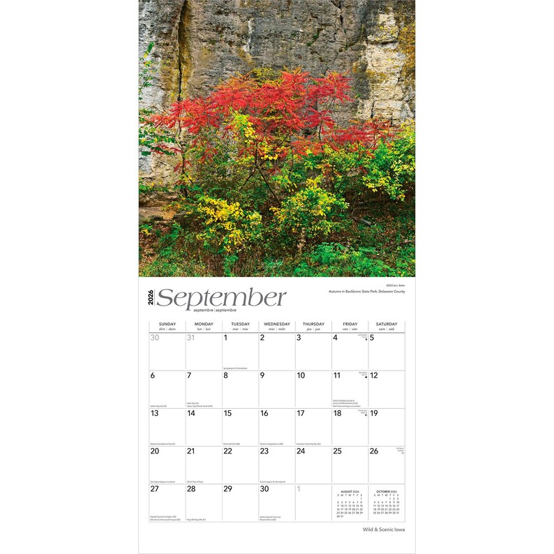 May include: A September 2026 calendar page with a photograph of autumn foliage in vibrant reds, yellows, and greens set against a rocky cliff. The calendar grid is at the bottom, displaying the days and dates.