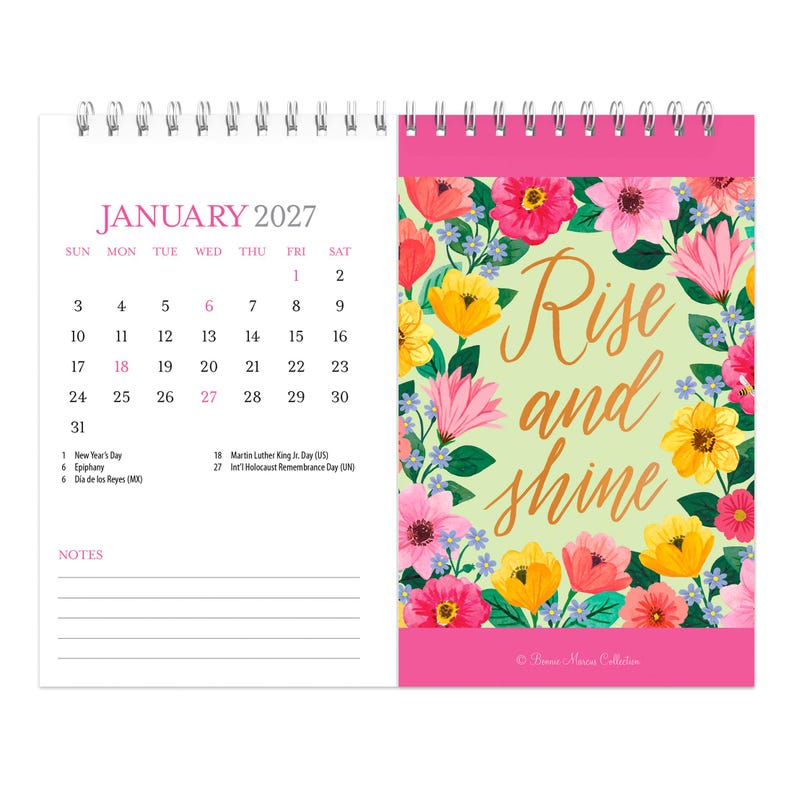 May include: A spiral-bound January 2027 calendar featuring a floral design on the right page with the text Rise and shine in gold script. The left page displays the calendar grid, the month, and a notes section with lines at the bottom.
