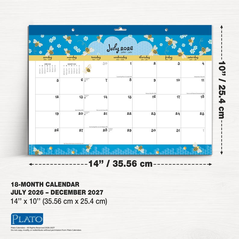 May include: An 18-month wall calendar, measuring 35.56 cm by 25.4 cm, showing the July 2026 calendar. The design features a blue border with bees and honeycomb patterns. The calendar covers the period from July 2026 to December 2027.