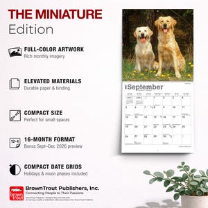 May include: A 2027 wall calendar titled THE MINIATURE Edition featuring a photograph of two golden retriever dogs in a grassy field. The calendar displays the month of September with a grid of dates, holidays, and moon phases, plus text details.