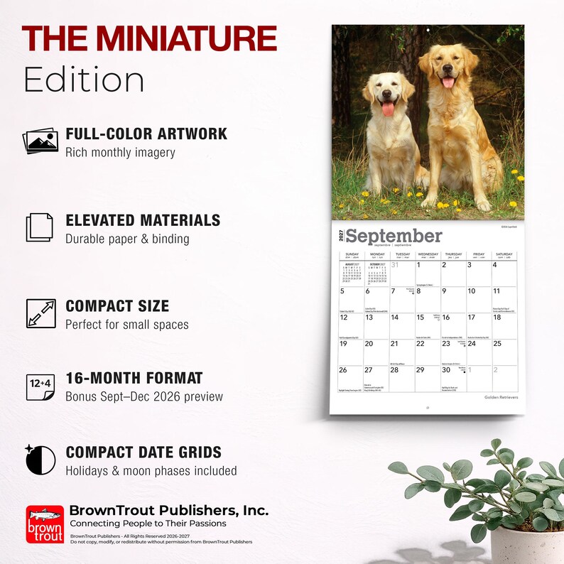 May include: A 2027 wall calendar titled THE MINIATURE Edition featuring a photograph of two golden retriever dogs in a grassy field. The calendar displays the month of September with a grid of dates, holidays, and moon phases, plus text details.