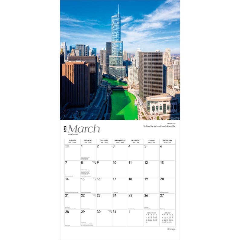 May include: A 2027 wall calendar for the month of March featuring a high-angle photograph of the Chicago River dyed bright green for St. Patrick's Day. The image shows skyscrapers under a blue sky, with a grid calendar layout below the photo.