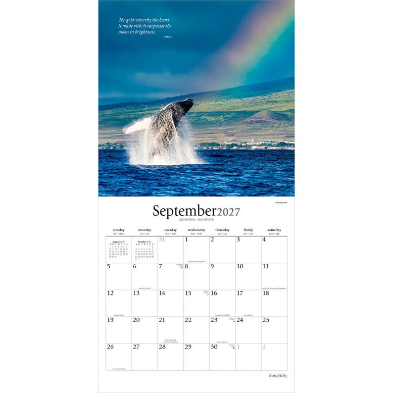 May include: A wall calendar for September 2027 featuring a photograph of a humpback whale breaching in deep blue ocean water with a rainbow in the sky. The text reads, The gold whereby the heart is made rich; it surpasses the moon in brightness.