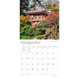 May include: A 2027 wall calendar for the month of September featuring a photograph of a red Japanese pagoda structure surrounded by lush green trees and foliage. The calendar grid displays the days of the month with clear black text on white.