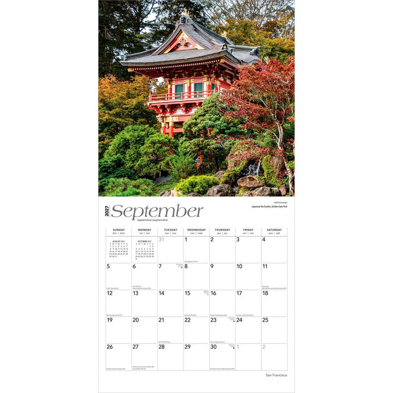 May include: A 2027 wall calendar for the month of September featuring a photograph of a red Japanese pagoda structure surrounded by lush green trees and foliage. The calendar grid displays the days of the month with clear black text on white.
