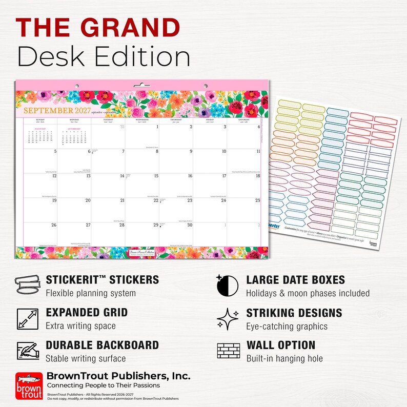 May include: A September 2027 desk calendar featuring a floral border with pink, red, and blue flowers. The calendar includes a grid for dates, a sheet of colorful rectangular stickers, and text detailing features like large date boxes and a durable backboard.