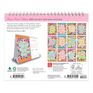 May include: A 2027 Bonnie Marcus Collection double-view desk calendar with a spiral binding. The calendar features floral-themed pages with inspirational text, a fold-out stand, and a grid layout for monthly planning on a white background.