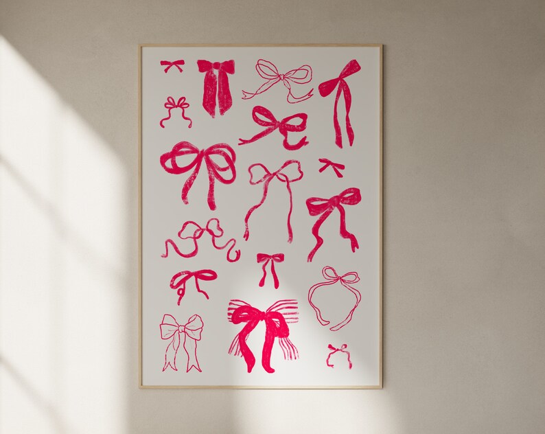 May include: A framed print featuring a collection of pink bow illustrations on a white background. The bows vary in style and size, creating a playful and decorative design. The print is encased in a simple, light-colored frame.