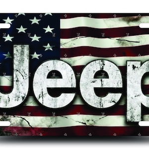 May include: Rectangular license plate with a distressed American flag design. The word "JEEP" is displayed in large, white, distressed letters across the flag's red, white, and blue background.