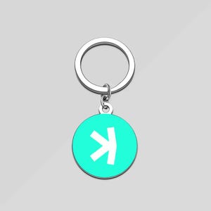 May include: A silver keyring with a turquoise round charm featuring a white arrow pointing to the right.