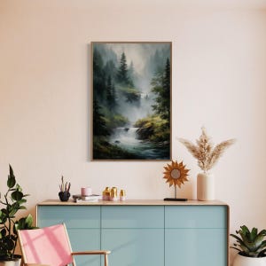 May include: A framed painting of a misty forest scene with a waterfall cascading down a rocky hillside. The painting features a muted color palette of greens, browns, and grays, creating a serene and tranquil atmosphere.