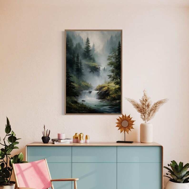 May include: A framed painting of a misty forest scene with a waterfall cascading down a rocky hillside. The painting features a muted color palette of greens, browns, and grays, creating a serene and tranquil atmosphere.