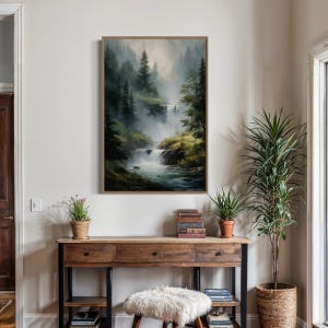 May include: A framed painting of a misty forest scene with a waterfall flowing through it. The painting is in a wooden frame and is hanging on a white wall.