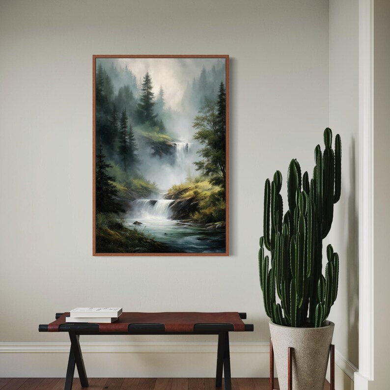 May include: A framed painting of a misty forest scene with a waterfall cascading down a rocky hillside. The painting features a variety of green trees and a blue stream.
