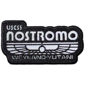 May include: A black and white embroidered patch with the text "USCSS Nostromo Weyland-Yutani" and a stylized winged symbol.