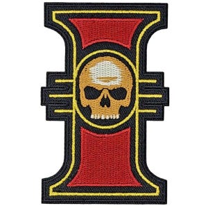 May include: A black and yellow embroidered patch with a red and yellow 'I' and a gold skull in the center.