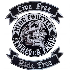 May include: A black and white embroidered patch featuring a central circular design with a skull and the text RIDE FOREVER. Above and below the circle are curved banners with the text LIVE FREE and RIDE FREE, accented by spade symbols.