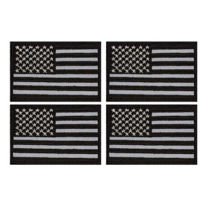 May include: Set of four black and white American flag patches. Each patch is approximately 2 inches by 3 inches.