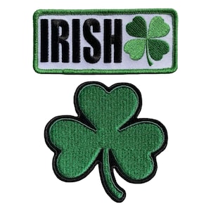 May include: Two green embroidered patches, one with the word "IRISH" in black letters and a green four-leaf clover, and the other a single green four-leaf clover.