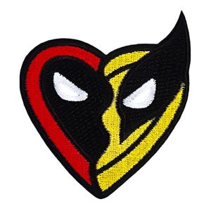 May include: A black and yellow heart-shaped patch with a red outline. The patch features two stylized faces with white eyes and black eyebrows.