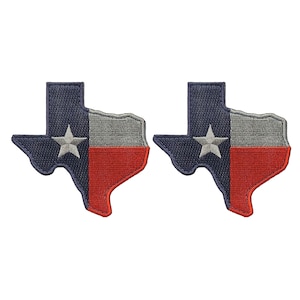 May include: Two embroidered patches in the shape of the state of Texas, featuring the Texas flag design. The patches are navy blue, gray, and red with a white star.