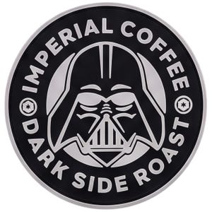 May include: A circular black and silver patch featuring a stylized graphic of a helmeted character in the center. The text IMPERIAL COFFEE is arched across the top, and DARK SIDE ROAST is arched across the bottom, with small circular icons on each side.