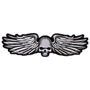 May include: A black and white embroidered patch featuring a skull with wings. The skull is detailed with eye sockets and a nose. The wings are spread out and have a feathered design.